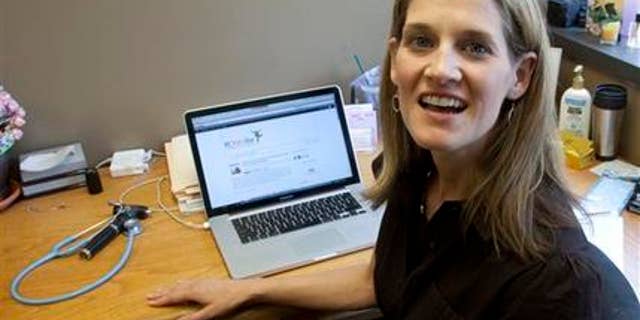 In this Friday, June 8, 2012 photo, Dr. Natasha Burgert talks about using social media in her practice at her office in Kansas City, Mo. There's a stereotype that says doctors shun technology that might threaten patients' privacy and their own pocketbooks. But a new breed of physicians is texting health messages to patients, tracking disease trends on Twitter, identifying medical problems on Facebook pages and communicating with patients through email. (AP Photo/Orlin Wagner)