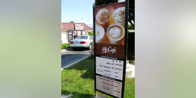 A drive-through menu displays McDonald's coffee offerings under the McCafe brand.