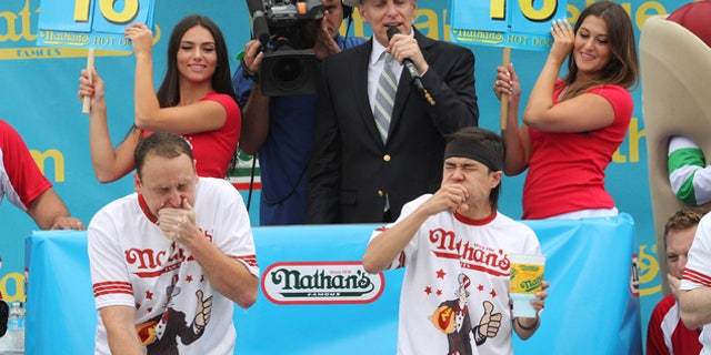 Joey Chestnut, left, and Matt Stonie face off in Nathan's Famous Fourth of July International Hot Dog Eating Contest men's competition, July 4, 2015.