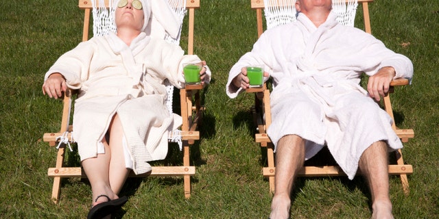 Mature couple detoxing during a do it yourself spa day in their backyard