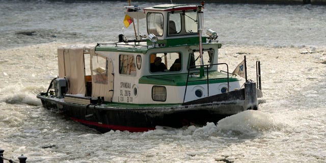 Feb. 3, 2012: A boat makes its way on the frozen river Spree in Berlin. After a warm January, Germany was hit by a cold snap with temperatures far below the freezing point.