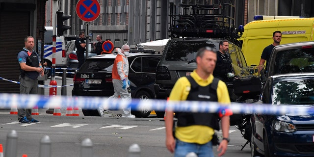 Officials said the attacker stabbed two officers before killing them with their own guns.