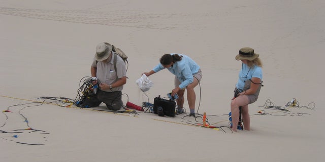 Set-up of geophone array on the Eureka Dune in Death Valley National Park, California.