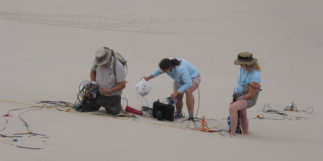Set-up of geophone array on the Eureka Dune in Death Valley National Park, California.