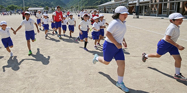 Children and residents conduct an evacuation drill on the assumption that North Korea may launch ballistic missile in Abu, Yamaguchi Prefecture on June 04, 2017