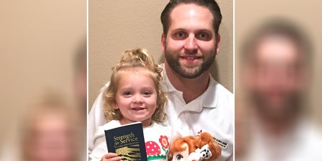 Evan Hunsberger, 29, seen here with his daughter Caydence, has worked tirelessly since the age of 13 to reprint and distribute "Strength or Service for God and Country." (Courtesy of Evan Hunsberger)