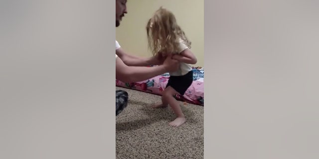 After being bit by a tick, Evelyn, above, struggled to stand on her own.