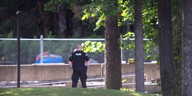 An Evergreen State College police officers keeps watch over campus as student evacuate following a "direct threat" on Thursday, June 1.