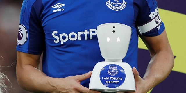 Everton v Newcastle United - Goodison Park, Liverpool, Britain - April 23, 2018 Everton's Phil Jagielka with a robot mascot before the match (Action Images via Reuters/Lee Smith)