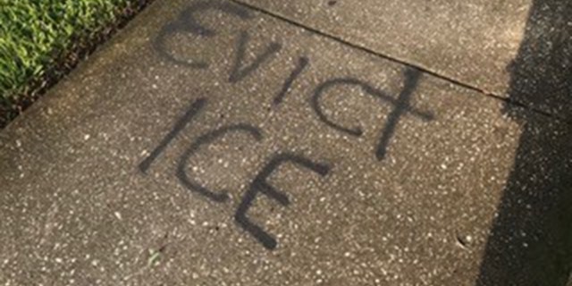 Protesters also spray painted 'EVICT ICE' outside Chuck Prather's house.
