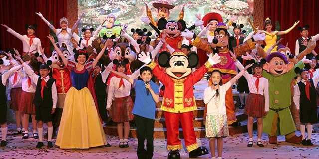 In this photo from 2011, Chinese children are shown performing with Disney actors to celebrate the ground-breaking of Shanghai Disneyland.