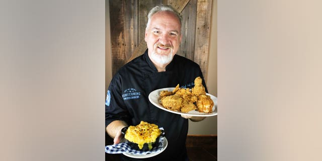 Chef Art Smith shows off the fried chicken and macaroni and cheese dishes planned for his new Orlando restaurant, Homecoming: Florida Kitchen and Southern Shine at Disney Springs.
