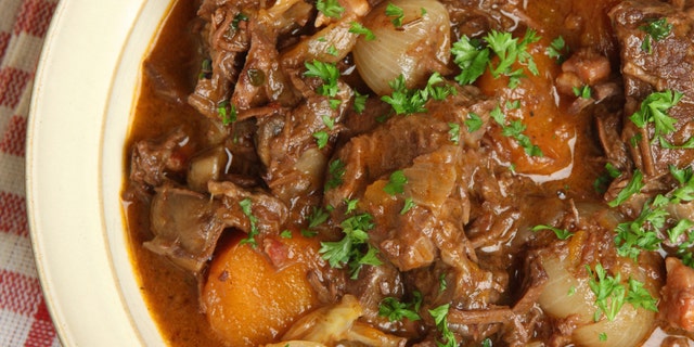 Beef bourguignon, traditional French stew with lardons, carrots, mushrooms and shallots.