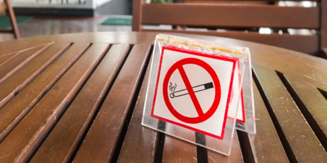 no smoking sign displayed in the public coffe shop