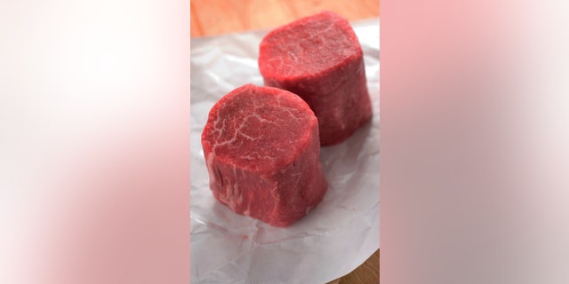 "Fresh from the butcher, two filet mignons on butcher paper. Shallow dof."