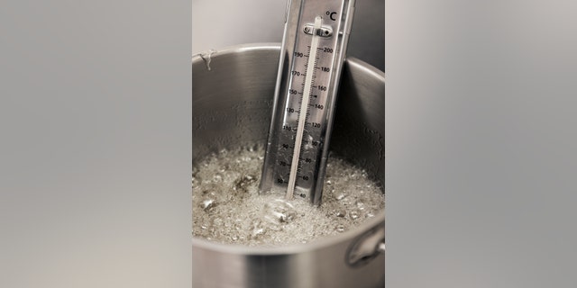 thermometer in a pot of boiling syrup