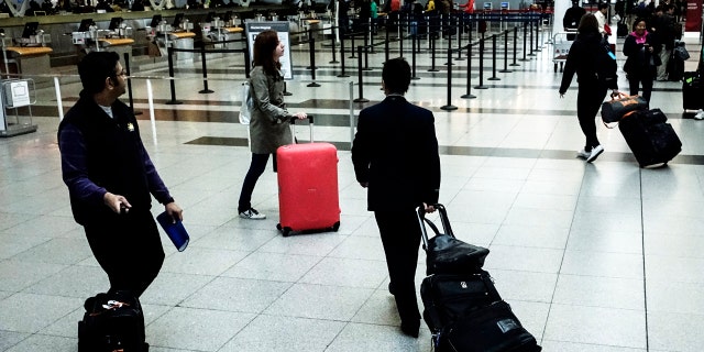 Passengers make their way to the security checkpoint at the John F. Kennedy airport in New York City.