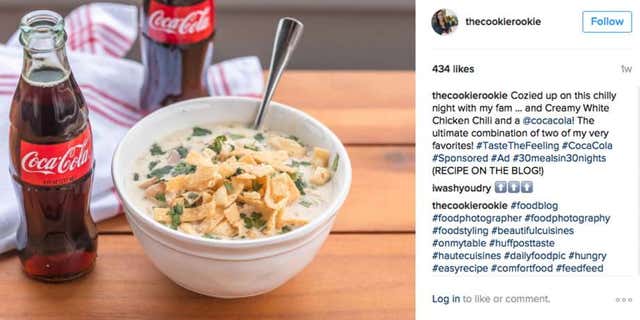 A social media post featuring a bottle of Coca-Cola next to a bowl of chicken chili posted by food blogger The Cookie Rookie.