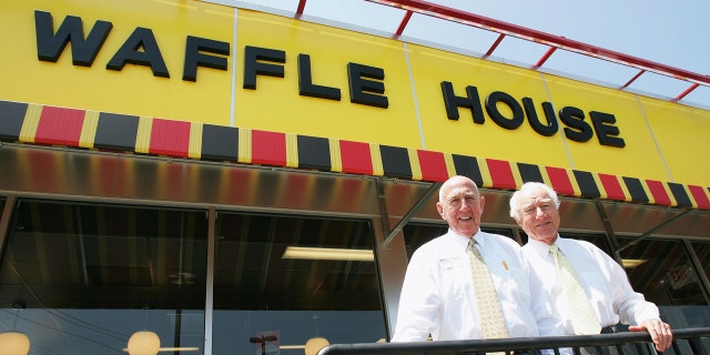 FILE - In this file photo taken July 26, 2005, Waffle House founders Joe Rogers Sr., left, and Thomas Francis Forkner Sr. pose in front of a Waffle House restaurant after eating lunch at the establishment in Norcross, Ga. Forkner, who jumped from real estate to the restaurant business when he co-founded Waffle House in the 1950s, has died weeks after the death of his business partner who helped him create the famous Southern diner chain. Waffle House said in a statement that Forkner died Wednesday, April 26, 2017, at age 98. (AP Photo/Ric Feld, File)