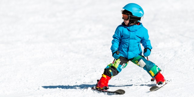 Little boy skiing on mountain