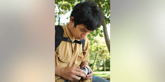 Photographer changes the camera lens in outdoor