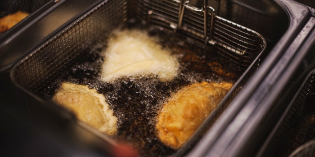 Dumplings being cocked in deep fryer, closeup