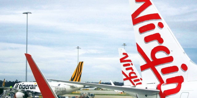 A Tigerair Australia plane sits on the tarmac near Virgin Australia aircraft at Melbourne's Tullamarine International Airport, Australia, October 12, 2016. Picture taken October 12, 2016. REUTERS/David Gray - RTX2ZF7U