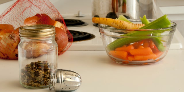 Ingredients for making soup, spices, onions, parsnips, celery, pot all placed on the kitchen counter top
