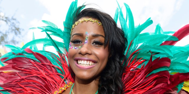 Bridgetown, Barbados - August 5, 2013: Colourful local woman enjoying the Barbados Crop Over festival. This is a traditional harvest festival that had its beginnings on the sugar cane plantations during the islands colonial period.