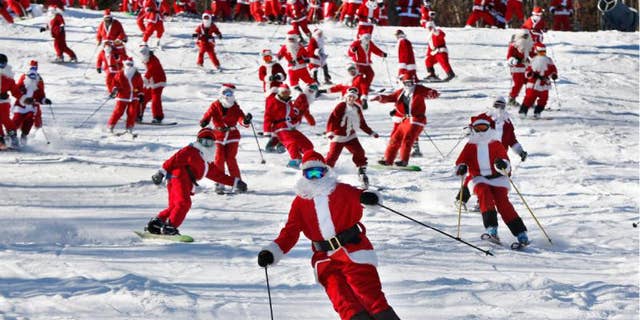 Skiers and snowboarders dressed as Santa take a run en masse at the Sunday River ski resort, Sunday, Dec. 6, 2015, in Newry, Maine. The annual Santa Sunday fundraising event raised $3,014 for the Sunday River Community Fund