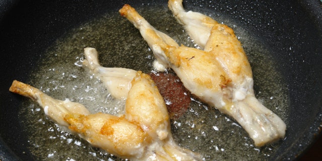 fried frog thighs in a pan