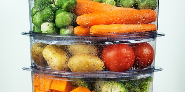 Healthy food in steamer, steam cooker with various vegetables and fruits