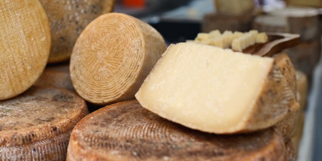 Pecorino - traditional Italian cheese of sheep's milk, street market, Italy.