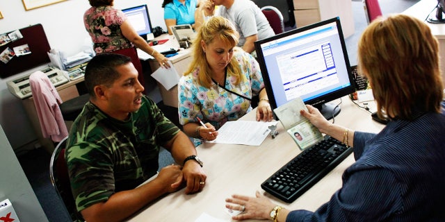 MIAMI - APRIL 13: Omar Garcia (L) and Giselle Bordin purchase tickets to Cuba from travel agent Marizela Somosa in the offices of Marazul Charters on April 13, 2009 in Miami, Florida. Today, U.S. President Barack Obama loosened travel restrictions for Cuban Americans traveling to Cuba as well as money transfers to the island. (Photo by Joe Raedle/Getty Images) *** Local Caption *** Omar Garcia;Gisell Bordin;Marizela Somosa