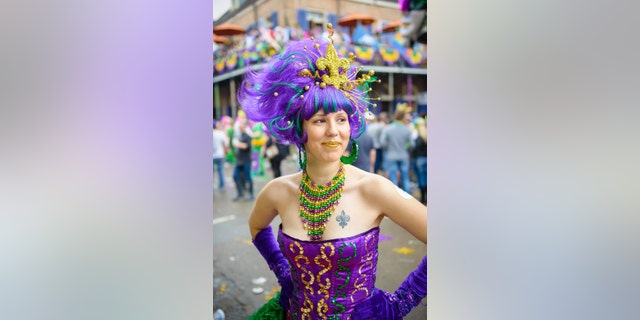 A young woman dressed up on Fat Tuesday on Bourbon Street in New Orleans, LA