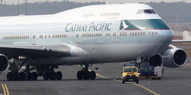 A Cathay Pacific Boeing B747-400 Aircraft is towed down the runway.