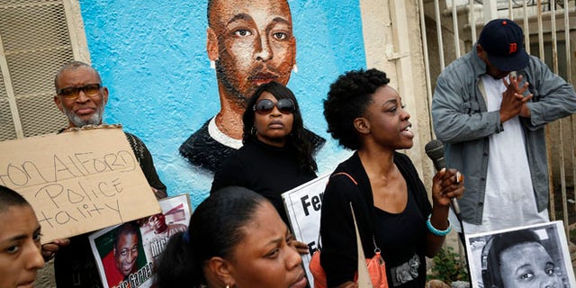 Dec. 1, 2014: Demonstrators rally against the Missouri grand jury's decision to not indict Darren Wilson for his fatal shooting of Michael Brown, in front of a mural of Ezell Ford, on the corner of Broadway and 65th Street in Los Angeles.
