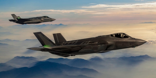 Fighter Jets flying over the foggy mountains at dusk (Credit: iStock)