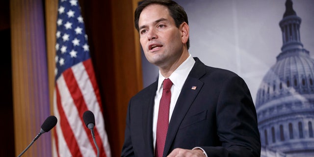 FILE - In this Dec. 17, 2014 file photo, Sen. Marco Rubio, R-Fla. speaks on Capitol Hill in Washington. Rubio seems to be moving toward a bid for the Republicans' presidential nomination, and late Sunday he joins Sens. Ted Cruz of Texas and Rand Paul of Kentucky for an audience with the conservative billionaire Koch brothers. (AP Photo/J. Scott Applewhite, File)