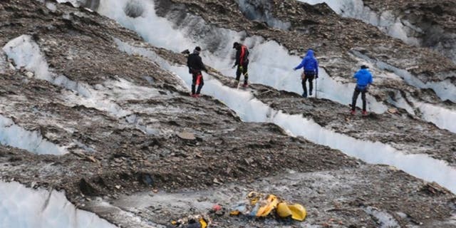 A specialized recovery team in 2012 searching for aircraft wreckage near the Colony Glacier.