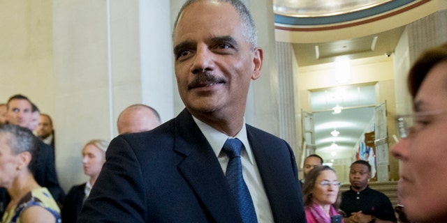 April 24, 2015: Attorney General Eric Holder bids goodbye to Justice Department employees as they leave the Justice Department in Washington.