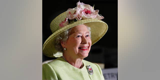 FILE - In this May 8, 2007 file photo, Britain's Queen Elizabeth II smiles as she is greeted by astronauts aboard the International Space Station, via video conference, during her visit to NASA's Goddard Flight Center in Greenbelt, Md.. On Monday Feb. 6, 2017, Queen Elizabeth II marks her Sapphire Jubilee, becoming the first British monarch to reign for 65 years. (AP Photo/J. Scott Applewhite, File)