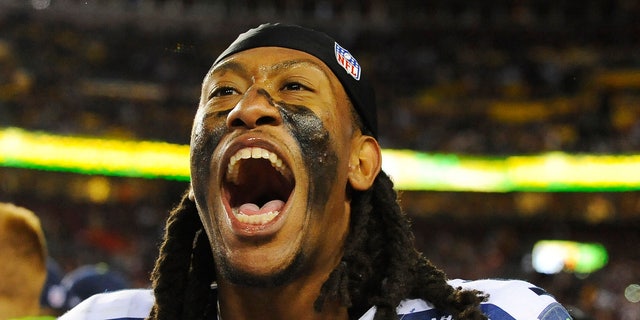 Seattle Seahawks defensive end Bruce Irvin celebrates his team's victory on the sidelines after an NFL wild card playoff football game against the Washington Redskins in Landover, Md., Sunday, Jan. 6, 2013. The Seahawks defeated the Redskins 24-14. (AP Photo/Richard Lipski)