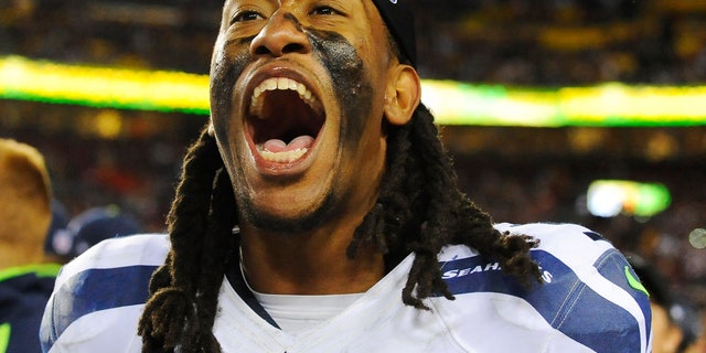 Seattle Seahawks defensive end Bruce Irvin celebrates his team's victory on the sidelines after an NFL wild card playoff football game against the Washington Redskins in Landover, Md., Sunday, Jan. 6, 2013. The Seahawks defeated the Redskins 24-14. (AP Photo/Richard Lipski)