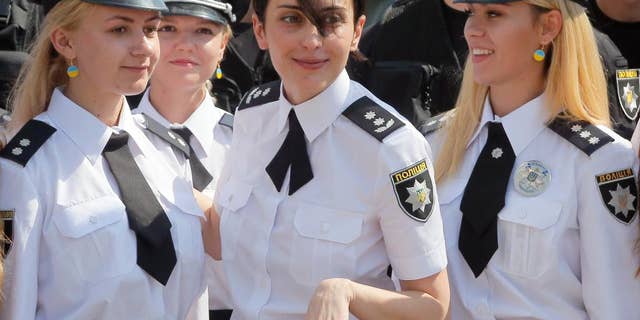 FILE In this Thursday, Aug. 4, 2016 file photo head of the National Police of Ukraine Khatiya Dekanoidze, centre, speaks with police officers during National Police Day in Kiev, Ukraine. Dekanoidze, who was driving reforms through the country's notoriously corrupt police force, has resigned Monday Nov. 14, 2016, after a year in the job, complaining of government pressure. (AP Photo/Efrem Lukatsky, File)