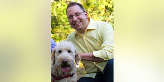 In this Sept. 2015 photo provided by Erin X. Smithers, Michael Templeton poses with his dog in Lincoln, R.I. Templeton, 38, said he was fired from his job as music director at the Church of St. Mary in Providence, a post he held for five years, after marrying his same-sex partner. An ideological tug of war over his firing illustrates the confusion in some U.S. Roman Catholic parishes over Pope Francis’ words on homosexuality. The pope's declaration “Who am I to judge?” in 2013 energized Catholics who had pushed the church to accept gays and lesbians. Three years later, some gay Catholics and supporters who had hoped for rapid acceptance find themselves stymied by many bishops and pastors. (Erin X. Smithers via AP)
