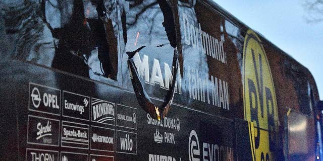 FILE - In this April 11, 2017 file photo a window of Dortmund's team bus is damaged after an explosion before the Champions League quarterfinal soccer match between Borussia Dortmund and AS Monaco in Dortmund, Germany. German prosecutors say they’re staging a reconstruction of last week’s attack on Borussia Dortmund’s team bus as they look for clues on the perpetrators. (AP Photo/Martin Meissner,file)