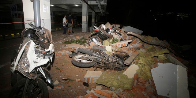 Debris on top of a motorcycles after an earthquake in Bali, Indonesia, Sunday, Aug. 5, 2018.