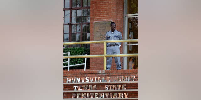 FILE - In this Sept. 21, 2011 file photo, a corrections officer keeps watch outside the Texas Department of Criminal Justice Huntsville Unit in Huntsville, Texas. A two-year dispute about execution drugs in the nation's most active death penalty state is returning to court as Texas seeks to keep secret the identity of whoever provided its drugs for lethal injections before a law last year clamped a firm lid on any supplier's name. (AP Photo/David J. Phillip, File)