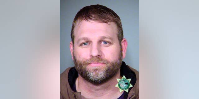 FILE--This Jan. 27, 2016, photo provided by the Multnomah County Sheriff's Office shows Ammon Bundy. Bundy and his brother, Ryan Bundy, are set to go on trial 9 months after the armed occupation of a wildlife refuge in Oregon. Government prosecutors are expected to begin opening statements Tuesday, Sept. 13, 2016, at the federal courthouse in Portland, Ore. (Multnomah County Sheriff via AP, file)